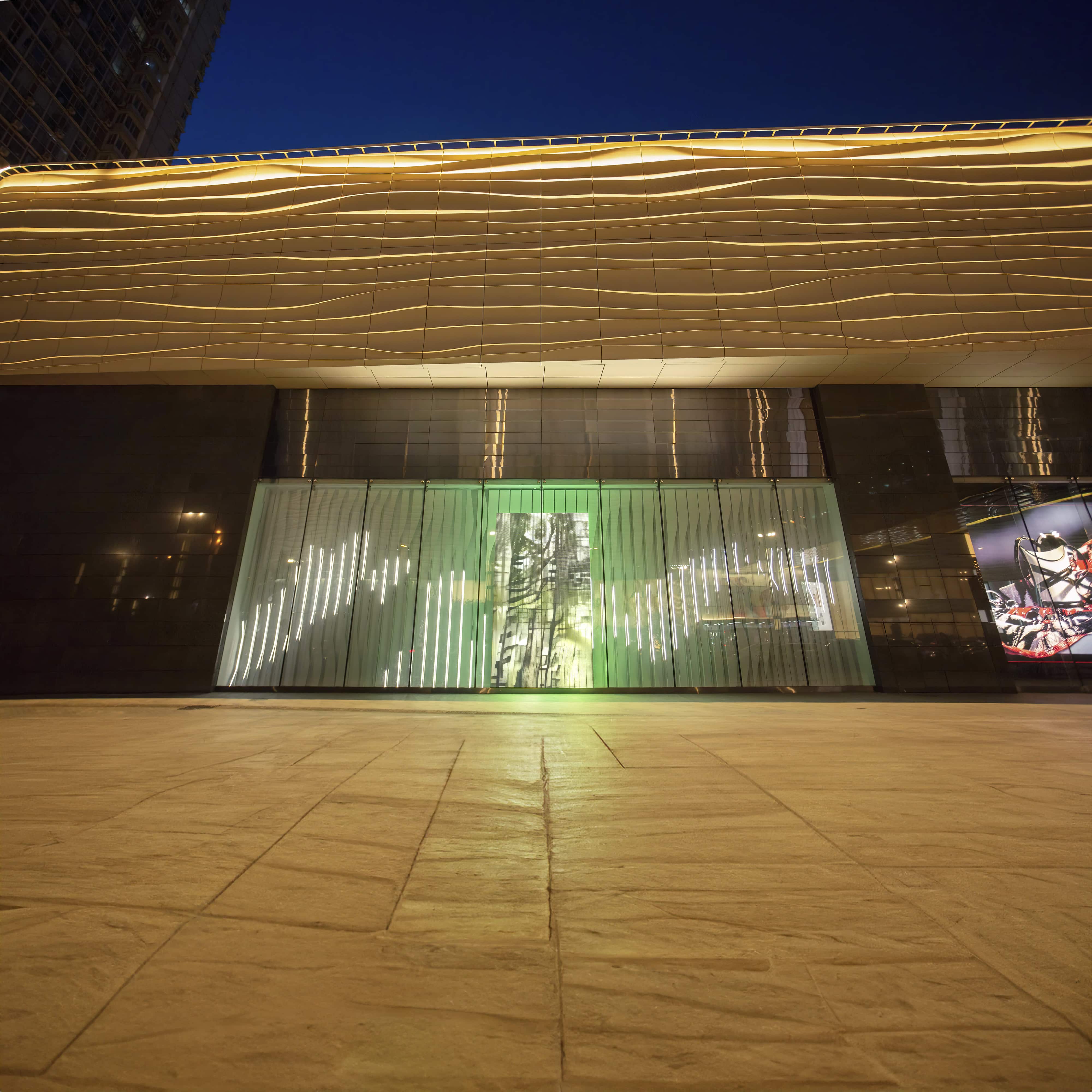 Alex Fischer & Polymetis, In Situ 在司徒, 2021, 20'x60' acrylic, steel, lights. 18'x9' LED Display. 24h animation loop as seen installed south west exterior Charter Mall Harbin, China. Photographed at night.